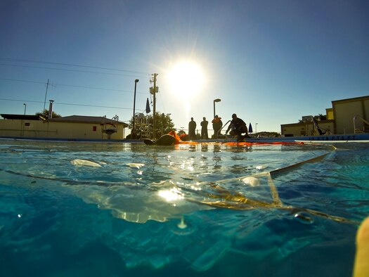 An IRVIN-GQ 6000 parachute stays afloat as each new F-35A Lightning II pilot completes required tasks during a water survival class on Eglin Air Force Base, Fla., Oct. 31, 2014. The parachute is tied to a floatation device created from PVC pipes enabling students to successfully swim out from under the parachute before it sinks to the bottom of the base pool. The octagon-shaped floatation device creates an effective training environment that provides students with a more closely simulated water landing. (U.S. Air Force photo/Staff Sgt. Marleah Robertson)