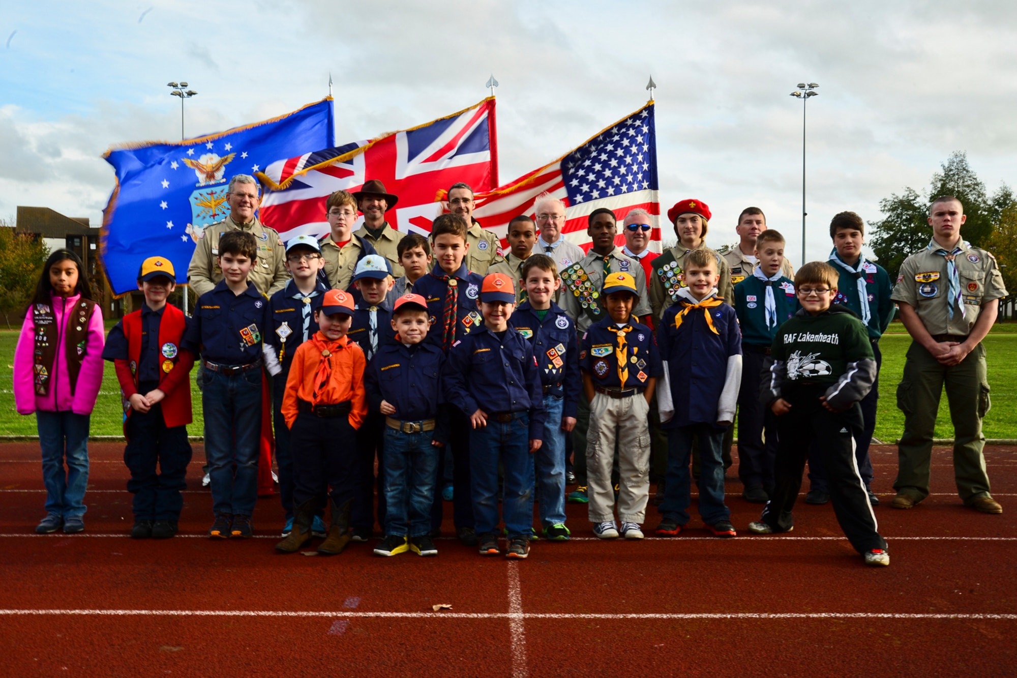 British and American scouts gather for a group photo before taking part in the opening ceremony of an annual football match between the joint-base Liberty Football Club of Royal Air Forces Lakenheath and Mildenhall and the Liverpool FC, Nov. 8, 2014, at RAF Lakenheath. This match highlighted the continued cooperation and relationship between the U.K. and the U.S. (U.S. Air Force photo by Airman 1st Class Erin R. Babis/Released)