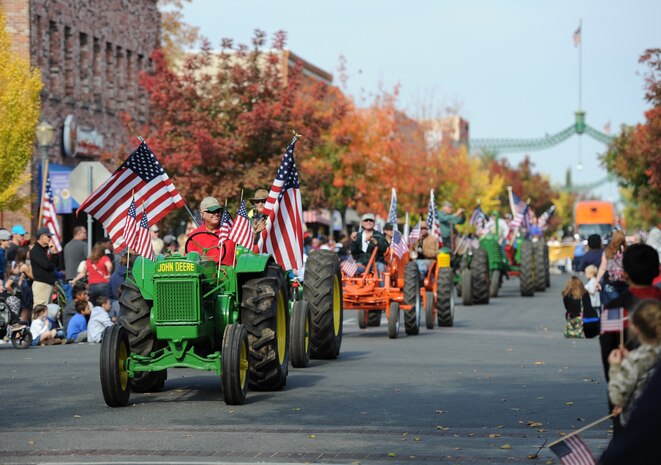 Local farmers ride vintage tractors during the Yuba/Sutter Veterans Day Parade in Marysville, Calif., Nov. 11, 2014. The local counties have a rich history in agriculture. (U.S. Air Force photo by Staff Sgt. Robert M. Trujillo/Released)