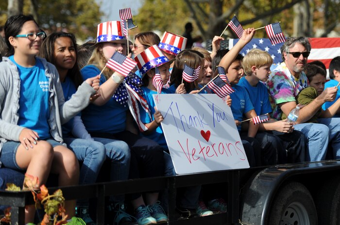 Local children hold up a sign thanking veterans during the Yuba/Sutter Veterans Day Parade in Marysville, Calif., Nov. 11, 2014. Veterans Day is celebrated throughout the U.S. to honor those who have served and are serving in the Armed Forces. (U.S. Air Force photo by Staff Sgt. Robert M. Trujillo/Released)