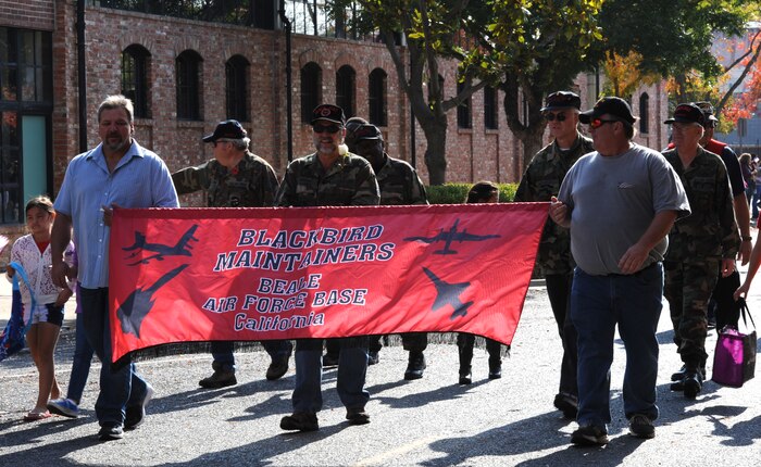 Members of the Blackbird Maintainers Group march during the Yuba/Sutter Veterans Day Parade in Marysville, Calif., Nov. 11, 2014. The SR-71 Blackbird called Beale Air Force Base home from 1966 to 1990. (U.S. Air Force photo by Staff Sgt. Robert M. Trujillo/Released)  