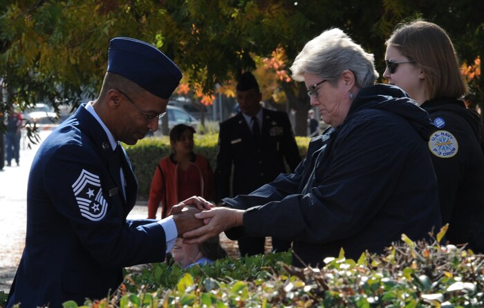 Chief Master Sgt.  Leslie N. Gould, 9th Reconnaissance Wing command chief, shakes hands with the local community during the Yuba/Sutter Veterans Day Parade in Marysville, Calif., Nov. 11, 2014. Veterans Day is celebrated throughout the U.S. to honor those who have served and are serving in the Armed Forces. (U.S. Air Force photo by Staff Sgt. Robert M. Trujillo/Released)