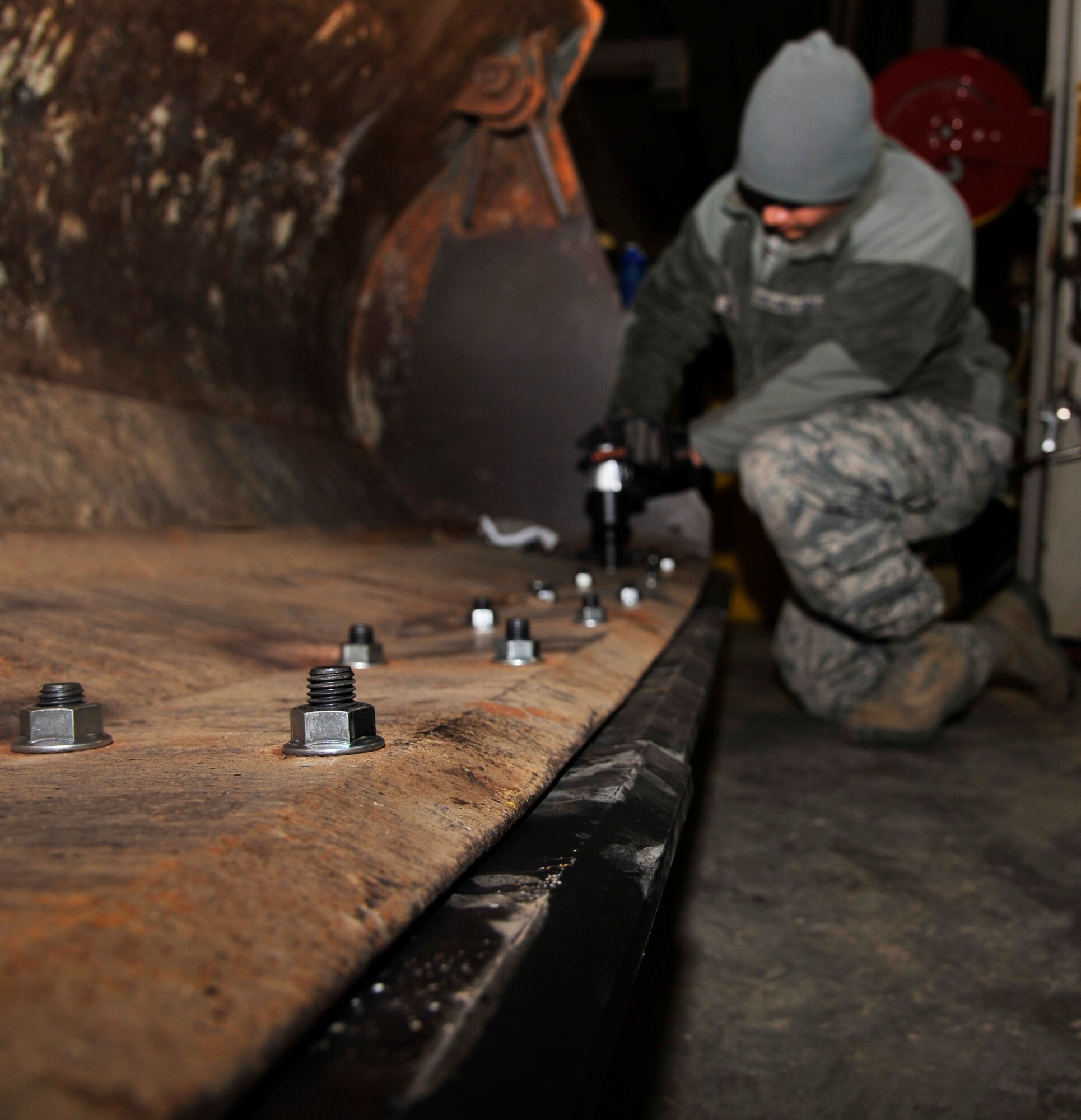 U.S. Air Force Staff Sgt. Nicholas Warkocz, 509th Civil Engineer Squadron supervisor, replaces loader bucket blades at Whitman Air Force Base, Mo., Nov. 12, 2014. The blades wear down from constant usage, requiring them to be replaced. (U.S. Air Force photo by Airman 1st Class Keenan Berry/Released)