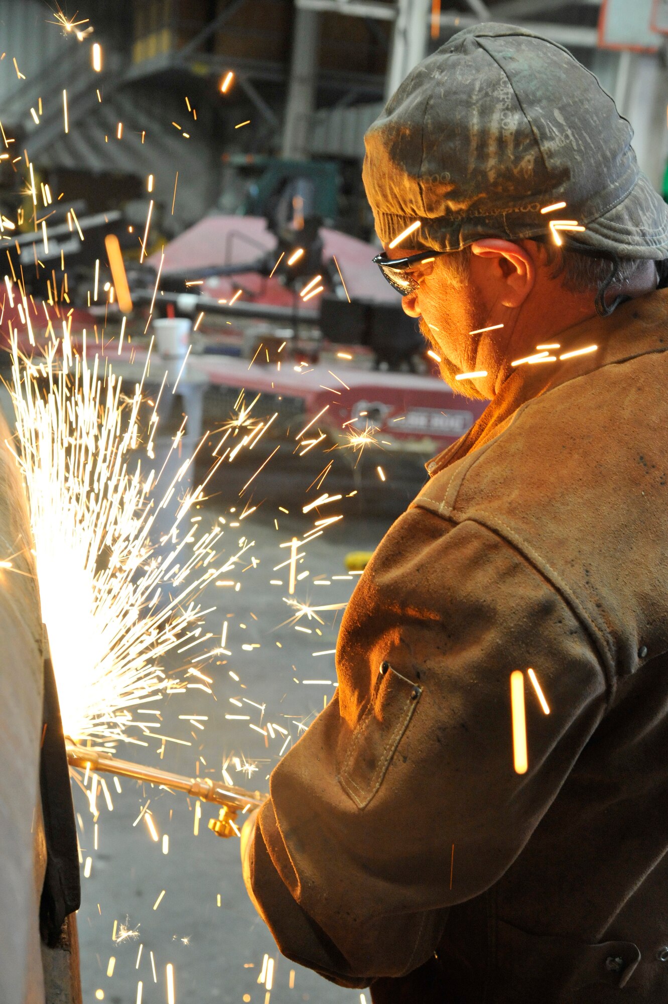 Bo Smith, 509th Civil Engineer Squadron tractor operator, wields the loader bucket at Whiteman Air Force Base, Mo., Nov. 4, 2014. This procedure is done to repair equipment damaged during operations. (U.S. Air Force photo by Airman 1st Class Keenan Berry/Released)