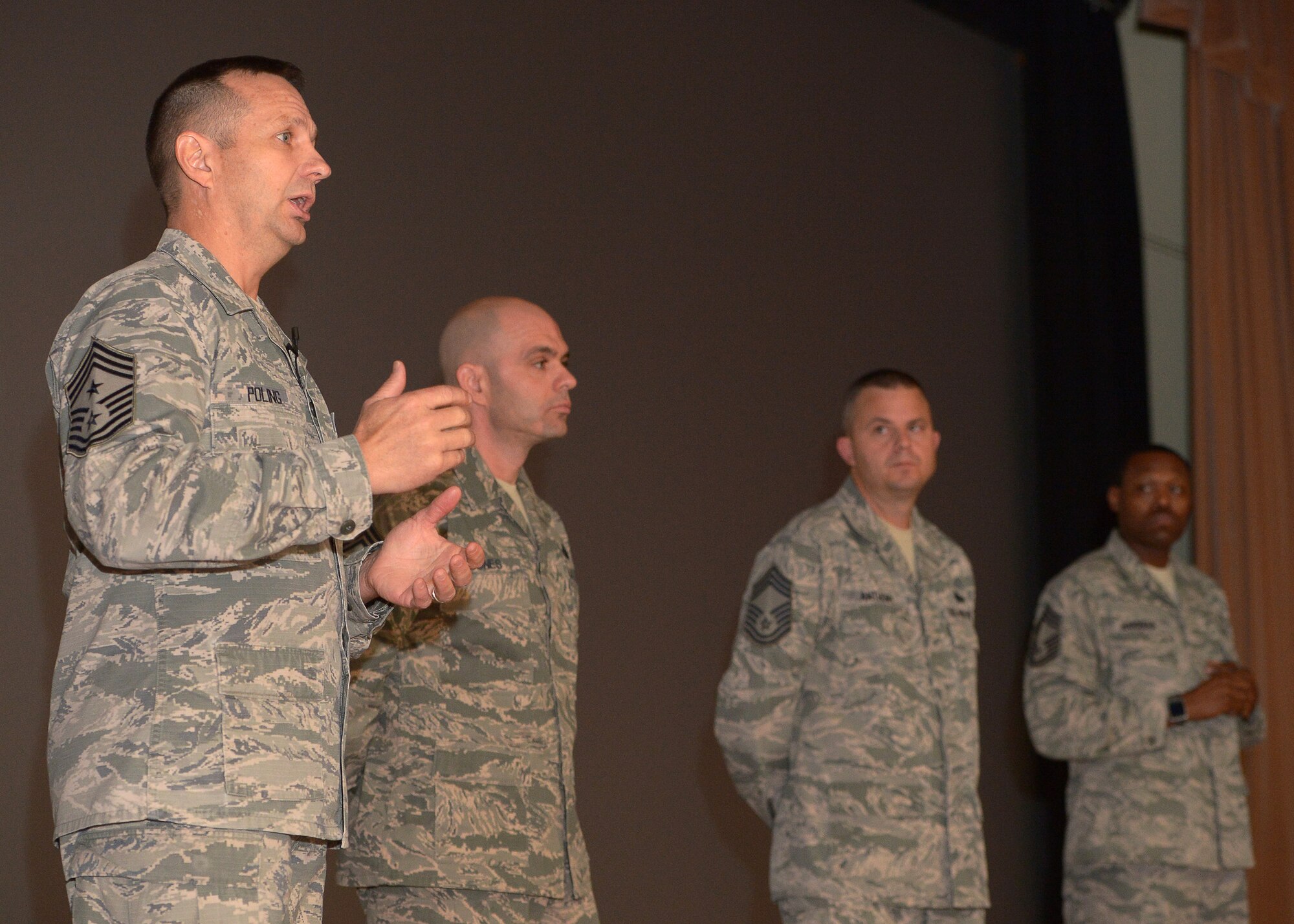 Enlisted Airmen listen as Command Chief Master Sgt. Craig Poling, 66th Air Base Group, answers a question during an Enlisted All-Call at the base theater, Nov. 12. The all-call provided enlisted Airmen the opportunity to ask the base’s senior enlisted leadership any questions they may have. (U.S. Air Force photos by Jerry Saslav)