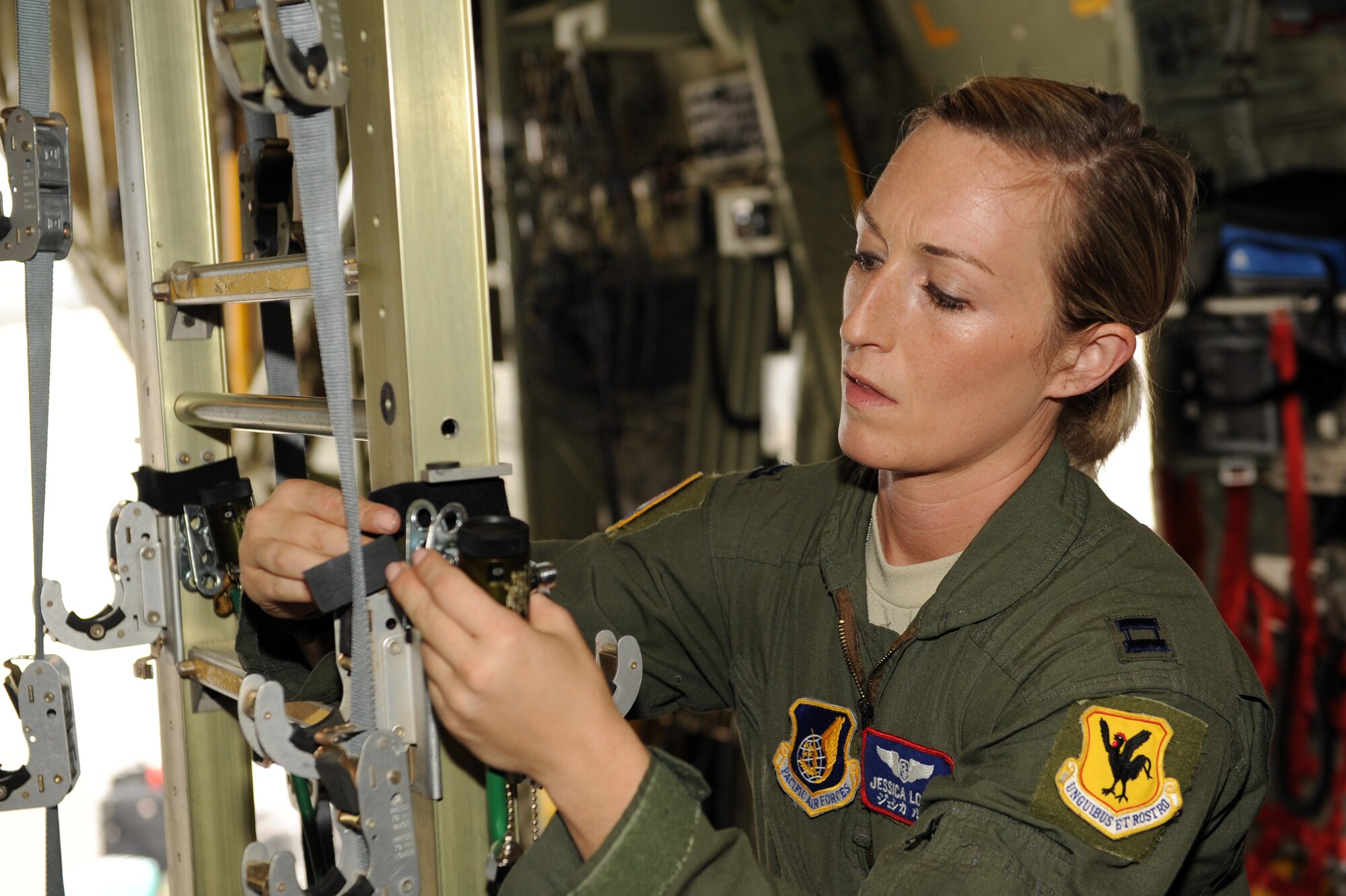 U.S. Air Force Capt. Jessica Looft, 18th Aeromedical Evacuation Squadron flight nurse, secures an oxygen hose to a litter rest on a U.S. Marine Corps C-130 during an exercise in support of Keen Sword on Kadena Air Base, Japan, Nov. 12, 2014. Participation in KS further enhances the Japan-U.S. alliance which remains a key strategic relationship in the Northeast Asia Pacific Region. (U.S. Air Force photo by Airman 1st Class Zade C. Vadnais/Released)