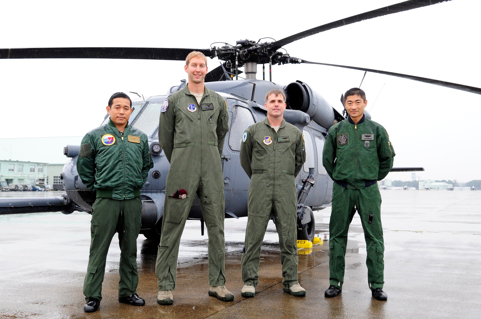 Commanders from the Japanese Self-Defense Force's Rescue Squadrons stand with U.S. Air Force Capt. Christian Braunlich, 212th Rescue Squadron combat rescue officer, and U.S. Air Force Lt. Col. Doug Dugdale, 33rd Rescue Squadron deployed commander, on the flightline at Komatsu Air Base, Japan, Nov. 9, 2014. Members from 33rd and 212th RQS arrived at Komatsu AB Nov. 7-9 in preparation for exercise Keen Sword 2015. During this exercise the combat rescue teams will conduct joint-bilateral training to increase the interoperability required to support the defense of Japan, respond to a potential crisis and offer humanitarian assistance. (U.S. Air Force photo by 2nd Lt. Erik Anthony/Released)