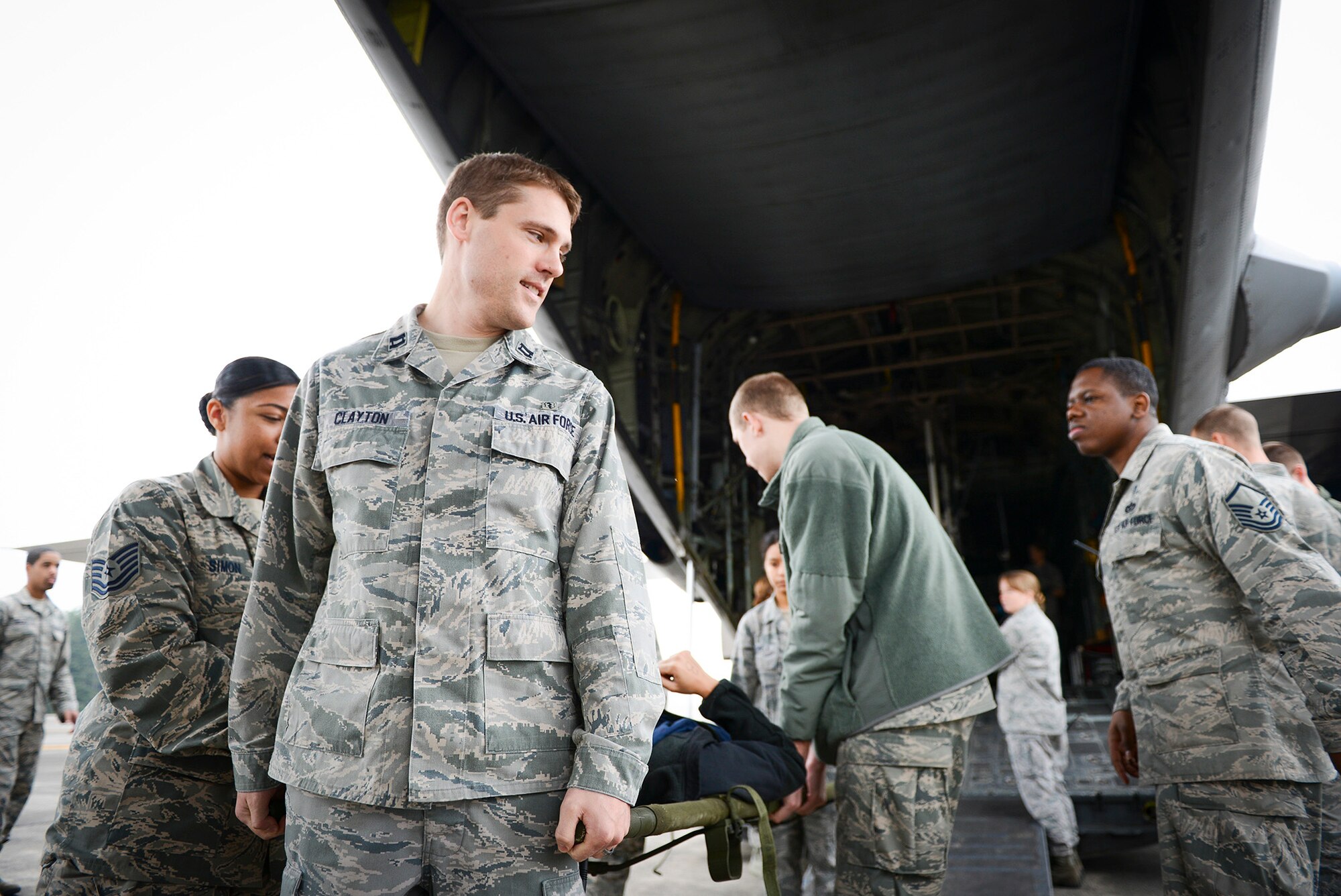 A patient is carried on a litter by members of the 374th Medical Group during medical evacuation training for Exercise Keen Sword 2015 at Yokota Air Base, Japan, Nov. 12, 2014. Manpower medical teams moved patients between aircraft, ground transport vehicles and medical facilities. (U.S.  Air Force photo by Staff Sgt. Cody H. Ramirez/Released)