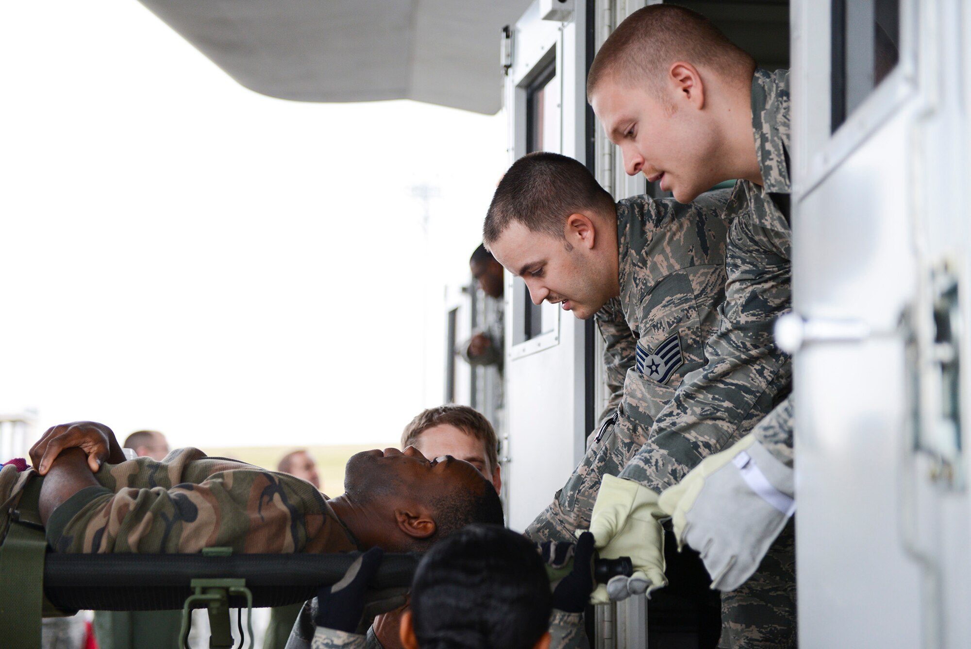 A patient litter is lifted onto a transport bus during medical evacuation training at Yokota Air Base, Japan, Nov. 12, 2014. The medevac training is part of Keen Sword 2015 and is aimed at improving military readiness and effectiveness during contingencies. (U.S. Air Force photo by Staff Sgt. Cody H. Ramirez/Released)