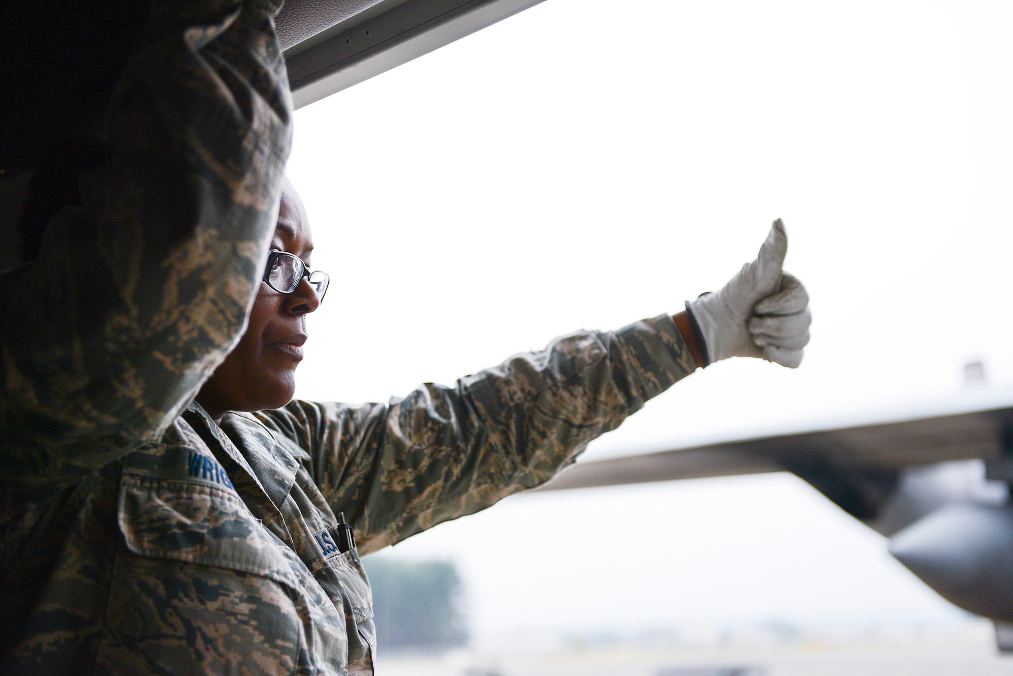 Tech. Sgt. Granette Wright, 374th Medical Group, signals ‘ready’ to medical personnel carrying a liter-bound patient during medical evacuation training for Exercise Keen Sword 2015 at Yokota Air Base, Japan, Nov. 12, 2014. The training included medevac flights, off-load and on-load of patients, transportation and field medical care. (U.S. Air Force photo by Staff Sgt. Cody H. Ramirez/Released)