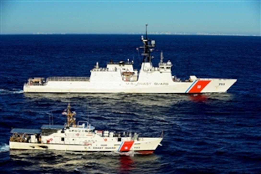 The U.S. Coast Guard cutter Hamilton cruises alongside the William Flores off Miami Beach, Fla., Nov. 11, 2014. The Hamilton is the 4th of eight planned Legend-class cutters, and is scheduled to be commissioned in home port Charleston, S.C., in December.