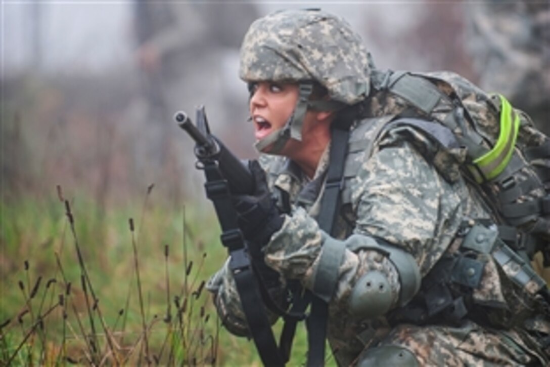 U.S. Army Spc. Kristen Stewart kneels down after giving a command in Sembach Kasarne, Germany, Nov. 13, 2014. Stewart pulled security during sergeant's time training. Steward is a human resources specialist assigned to the 30th Medical Brigade.