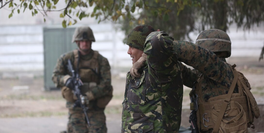 Marines from Black Sea Rotational Force 14 and Romanian soldiers conduct personnel searching and detaining classes during exercise Platinum Lynx 15.3 in Focsani, Romania. Training included weapons familiarization classes, live-fire ranges and call-for-fire ranges, among more. (U.S. Marine Corps photo by Lance Cpl. Ryan Young/released)