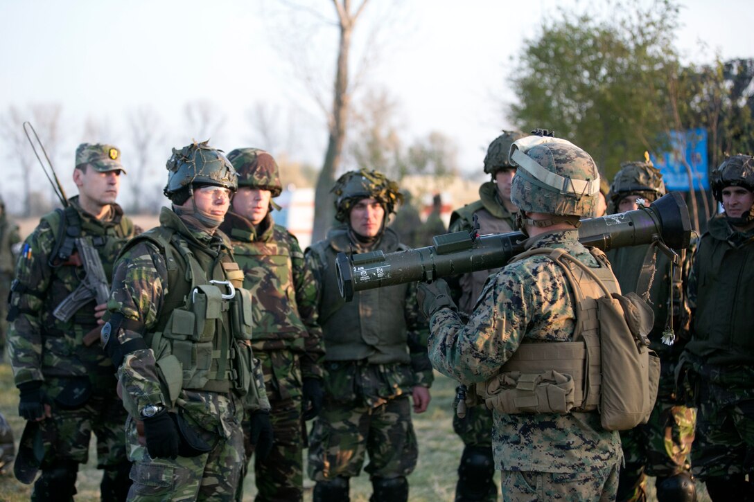 A Marine from Black Sea Rotational Force 14 explains how to use an AT4 to Romanian soldiers during Platinum Lynx 15.3. Marines and Sailors on BSRF 14 worked hand-in-hand with Romanian Land Forces during exercise Platinum Lynx 15.3 in Focsani, Romania. Training included weapons familiarization classes, live-fire ranges and call-for-fire ranges, among more. (U.S. Marine Corps photo by Lance Cpl. Ryan Young/released)