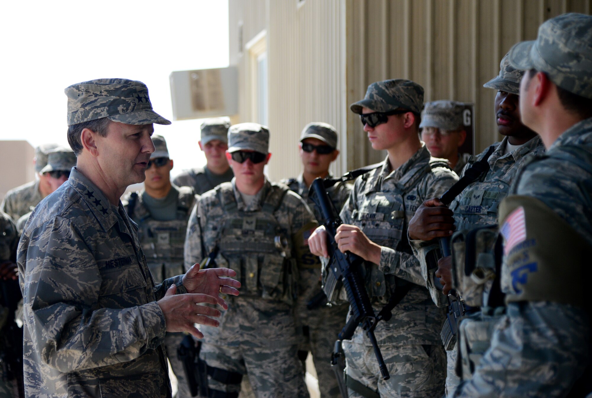 U.S. Air Force Lt. Gen. John Hesterman III, left, commander of U.S. Air Forces Central Command, speaks to 379th Expeditionary Security Forces Squadron members during his visit Nov. 13, 2014, at Al Udeid Air Base, Qatar. Hesterman and Chief Master Sgt. Ramon Colon-Lopez, U.S. AFCENT command chief, toured facilities and spoke with Airmen during their visit here. (U.S. Air Force photo By Senior Airman Kia Atkins)