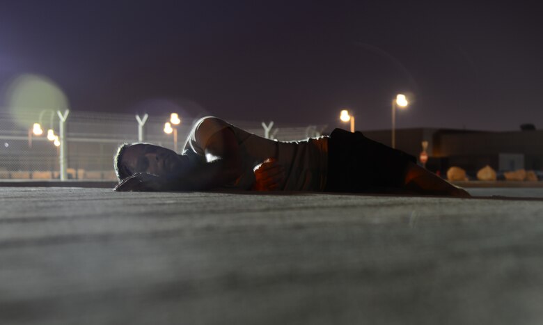 A simulated victim of a vehicle accident lays on the ground during a mass casualty exercise Nov. 10, 2014, at Al Udeid Air Base, Qatar. During this exercise scenario, several Airmen played simulated victims of an accident where a vehicle struck pedestrians. The training provided by these types of exercises keep Airmen ready to respond to real-world scenarios at a moment’s notice. (U.S. Air Force photo by Senior Airman Kia Atkins)