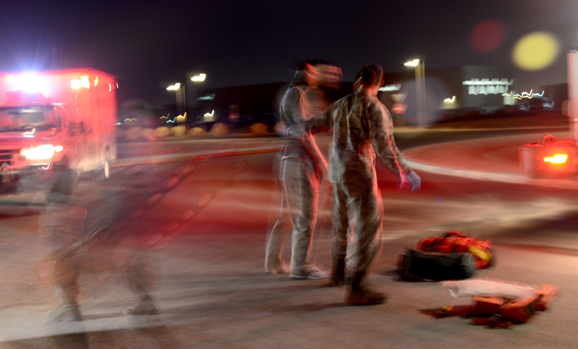 First responders rush to provide medical attention to simulated victims of a vehicle accident during a mass casualty exercise Nov. 10, 2014, at Al Udeid Air Base, Qatar. In this exercise, the victims were riding their bikes when a van collided with them. The training provided by these types of exercises keep Airmen ready to respond to real-world scenarios at a moment’s notice. (U.S. Air Force photo by Senior Airman Kia Atkins)