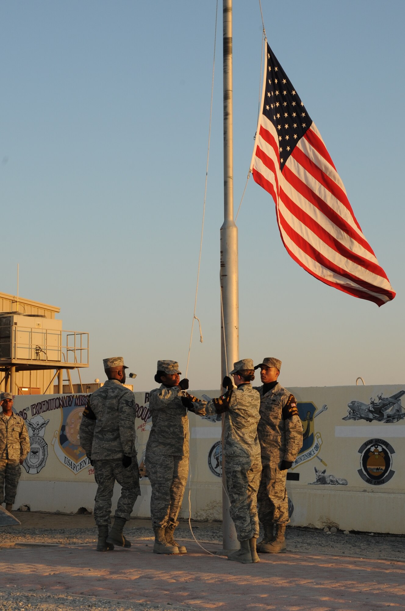 Airmen from the 386th Air Expeditionary Wing stand at parade rest during a Veteran’s Day retreat ceremony at The Rock Nov. 11, 2014. The Air Force Sergeants Association Satellite Chapter 1674 sponsored the ceremony as its inaugural event here. (U.S. Air Force photo by Master Sgt. Eric Petosky/released)