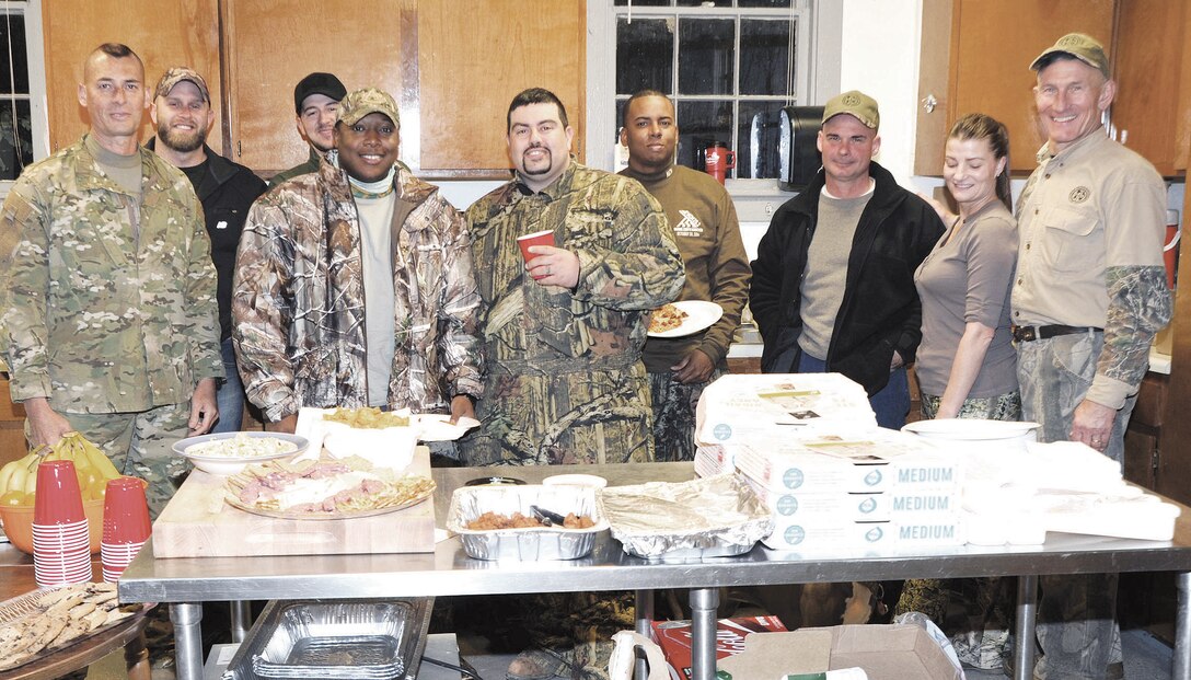 Wounded warriors, hunting guides, and other volunteers gather for a meal in the kitchen of the game check station about Marine Corps Base Quantico on Nov. after a long, chilly day in the field hunting. 