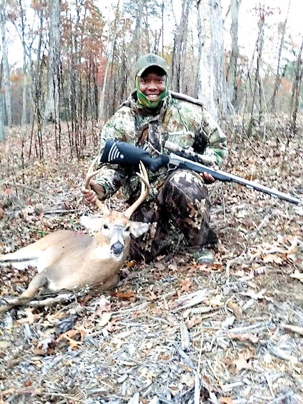 Navy chief Troy Biggham, a wounded warrior from Fort Belvoir, shows off the 7-point buck he shot on Nov. 8 during the muzzleloader hunt about Marine Corps Base Quantico. 