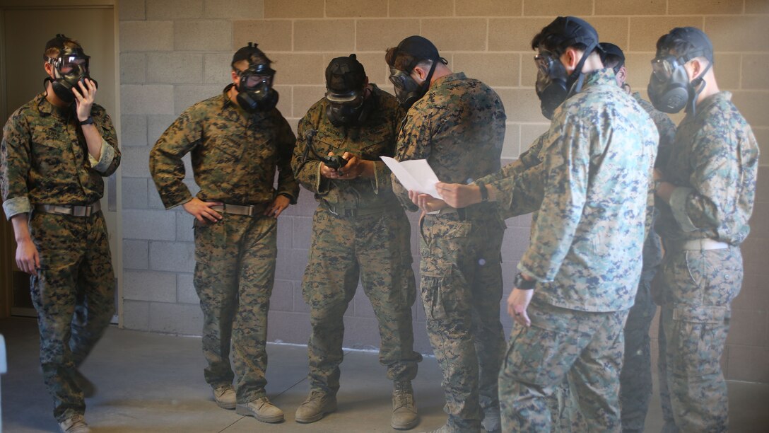 Marines with Force Company, 1st Reconnaissance Battalion, 1st Marine Division program radios and memorize targets while in the gas chamber aboard Marine Corps Base Camp Pendleton, Calif., Nov. 7, 2014. The gas chamber tested their mental fortitude by conducting those tasks while dealing with the stress of the gas.