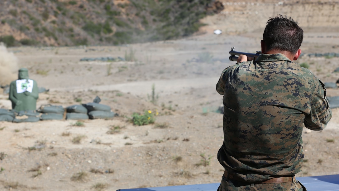 Corporal James Lafrance, a Reconnaissance Marine with Force Company, 1st Reconnaissance Battalion, 1st Marine Division, shoots targets with a shotgun during a physical training exercise aboard Marine Corps Base Camp Pendleton, Calif., Nov. 7, 2014. The eight-mile hike had multiple events along the route to test the Marines’ proficiency with various weapon systems.