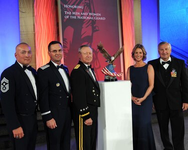 Army Gen. Frank Grass, chief, National Guard Bureau, receives the American Patriot Award on behalf of the National Guard from Cathleen Pearl, the president and chief executive officer, National Defense University Foundation and Albert Zimmerman, chairman of the National Defense University Foundation Board of Directors, Washington, D.C., Nov. 13, 2014. Grass, along with Air Force Lt. Gen. Joseph L. Lengyel, and Chief Master Sgt. Mitch Brush, senior enlisted advisor to the chief, National Guard Bureau were presented the award which recognizes exceptional leaders who dedicate their lives to enhancing human security and global stability.