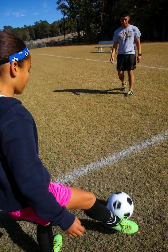 Roberto Ponce, assistant soccer coach for team Fury and Sacramento, Ca. native, kicks a ball around with 11-year-old player Ariana Cassel, a Norristown, Pa. native.   Ponce coached a team of 10-12 year-olds for two consecutive years and led them through an undefeated season in 2014.