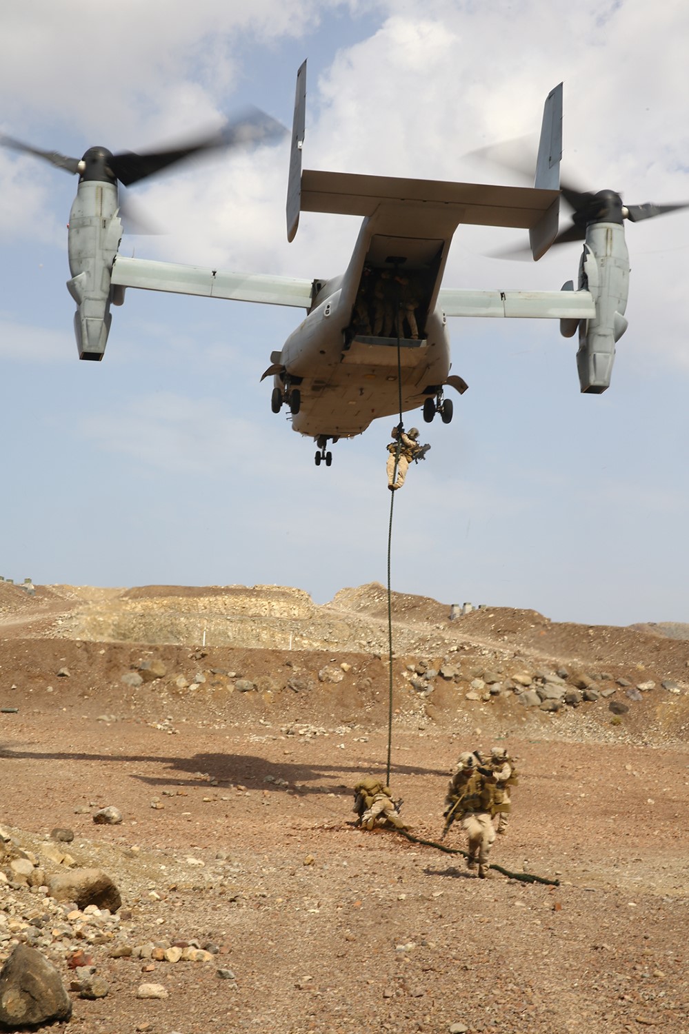 U.S. Marines with Fox Company, Battalion Landing Team 2nd Battalion, 1st Marines, 11th Marine Expeditionary Unit (MEU), fast-rope from an MV-22B Osprey with Marine Medium Tiltrotor Squadron 163 (Reinforced), 11th MEU, during sustainment training in D'Arta Plage, Djibouti, Nov. 11. The 11th MEU is a forward-deployed, flexible sea-based Marine Air-Ground Task Force in the U.S. 5th Fleet area of responsibility. (U.S. Marine Corps photo by Cpl. Jonathan R. Waldman/Released)