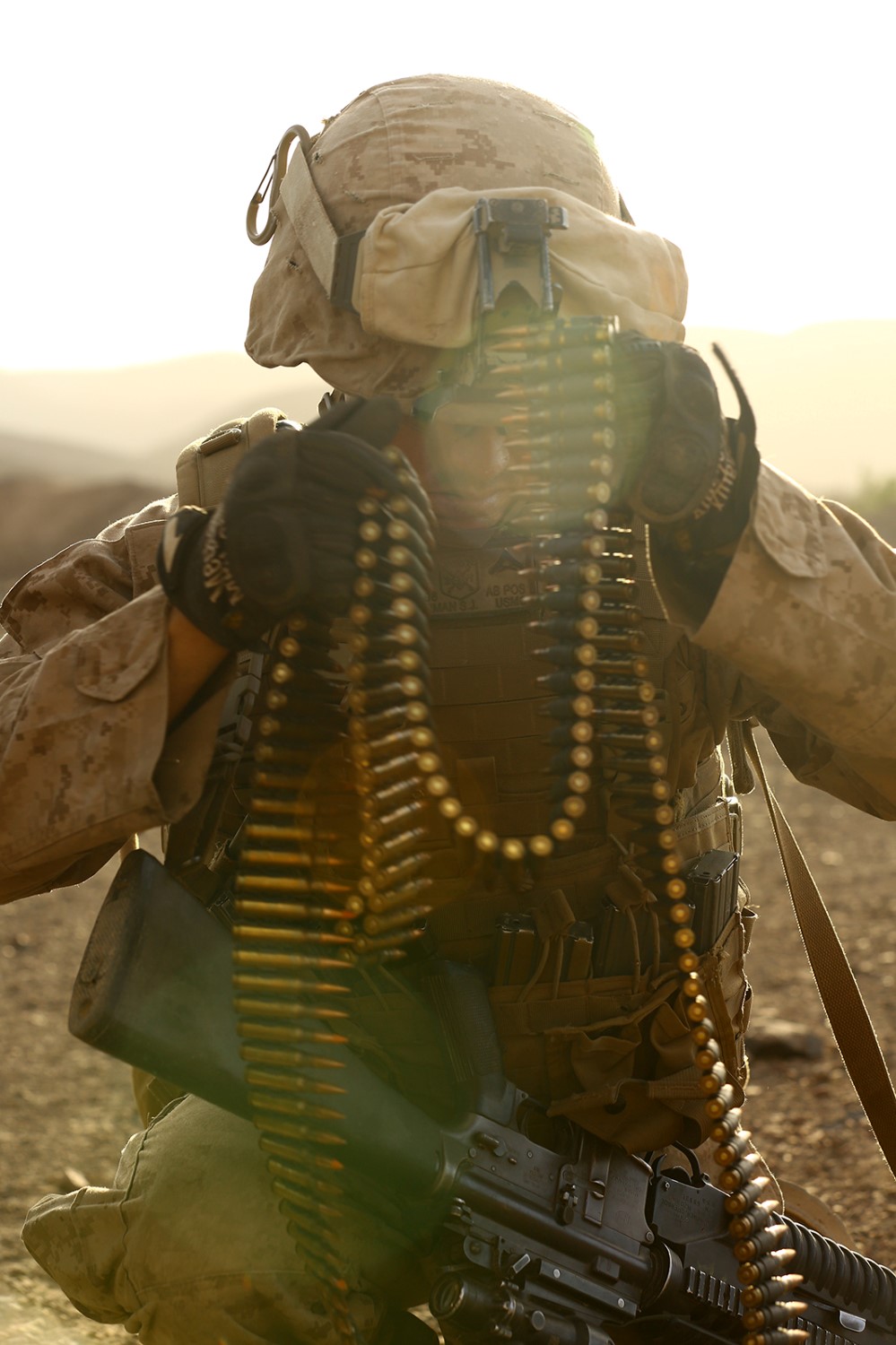 A U.S. Marine with Fox Company, Battalion Landing Team 2nd Battalion, 1st Marines, 11th Marine Expeditionary Unit (MEU), prepares machine gun ammunition for a known-distance range during sustainment training in D'Arta Plage, Djibouti, Nov. 12. The 11th MEU is deployed to maintain regional security in the U.S. 5th Fleet area of responsibility. (U.S. Marine Corps photo by Cpl. Jonathan R. Waldman/Released)