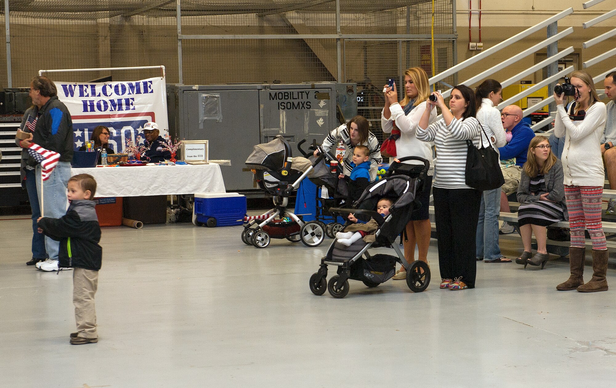 Families and friends wait for Air Commandos to return from deployment during Operation Homecoming at Hurlburt Field, Fla., Nov. 7, 2014. Operation Homecoming is an event that allows family members and friends to welcome home their loved ones who were deployed to various places around the world. (U.S. Air Force photo/Senior Airman Kentavist P. Brackin)