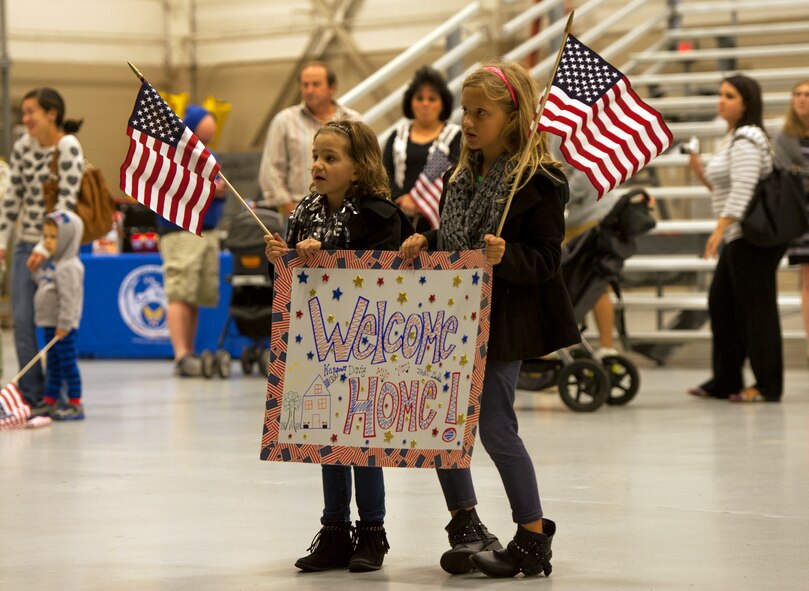 Kennedy Romin, age six, and Madelyn Romin, age eight, wait for their father to return from his deployment during Operation Homecoming at Hurlburt Field, Fla., Nov. 7, 2014. Family and friends were among the first to greet returning Air Commandos. (U.S. Air Force photo/Senior Airman Kentavist P. Brackin)