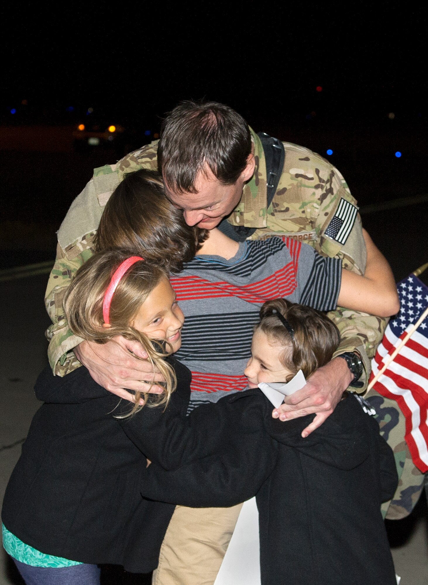 Maj. Timothy Romin, MC-130H Combat Talon II aircraft navigator for 15th Special Operations Squadron, is welcomed home by his family during Operation Homecoming on Hurlburt Field, Fla., Nov. 7, 2014. Operation Homecoming allows family and friends to welcome home their loved ones who are returning from deployment. (U.S. Air Force photo/Senior Airman Kentavist P. Brackin)