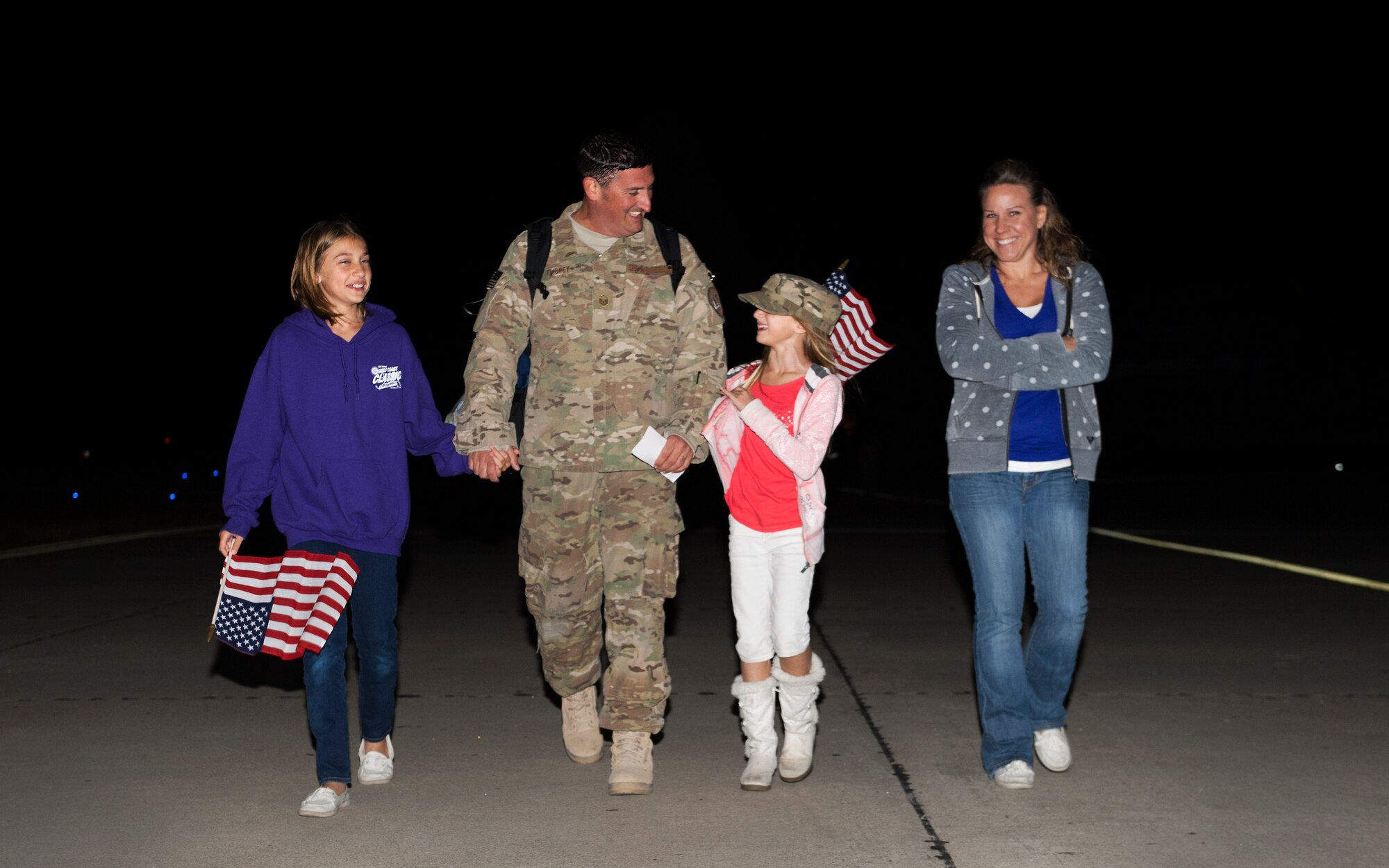 Master Sgt. Ryan Embrey, 901st Special Operations Aircraft Maintenance Squadron crew chief, is greeted by his family, after returning from deployment, during Operation Homecoming at Hurlburt Field, Fla., Nov. 7, 2014. Operation Homecoming allows family and friends to welcome home their loved ones who are returning from deployment. (U.S. Air Force photo/Senior Airman Kentavist P. Brackin)