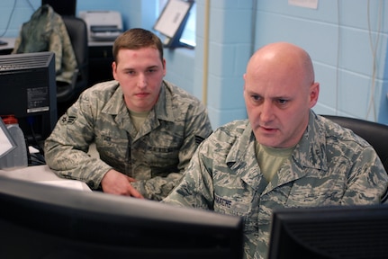 Senior Master Sgt. Stephen Gamache and Senior Airman Christopher Tuck track weather systems moving across Virginia during the snow storms that ravaged the region in February 2010.