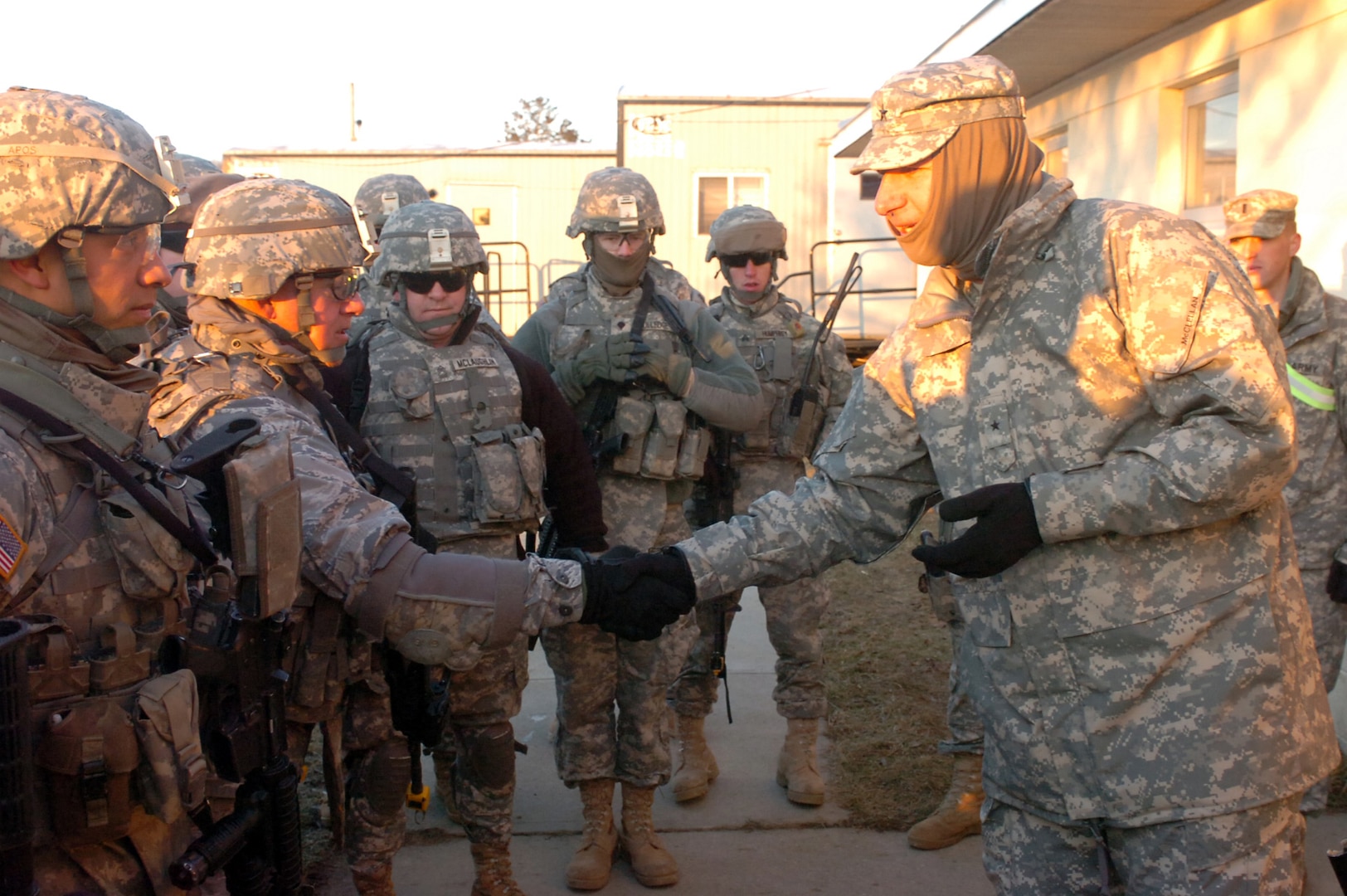Army Brig. Gen. Roger McClellan, right, the joint force land component
commander of the Arkansas National Guard, presents a commander's coin to Air National Guard Lt. Col. David Sheely, team leader of the agriculture
specialists of the Arkansas Agriculture Development Team. The presentation was made as the ADT Team continued training toward a March deployment to Afghanistan to assist farmers in redeveloping the nation's agricultural productivity Feb. 26.