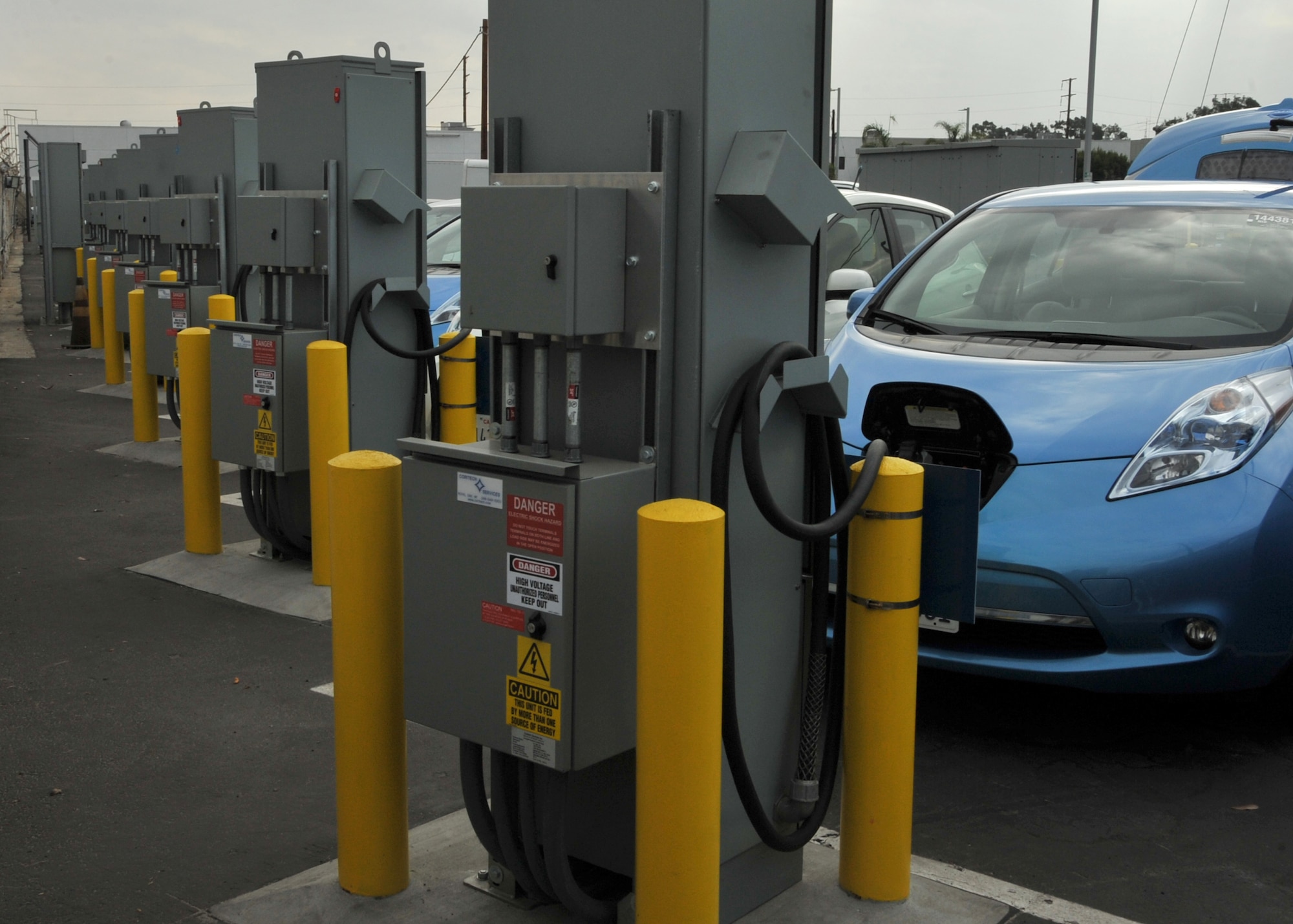 Airmen from Los Angeles Air Force Base learn how to use charging equipment for the base's new electric vehicle fleet during a training demo Oct. 31, 2014, in El Segundo, Calif.  When not in use, the vehicle's batteries can switch charging direction and feed their energy back to the base's power grid. (U.S. Air Force photo/Sarah Corrice)