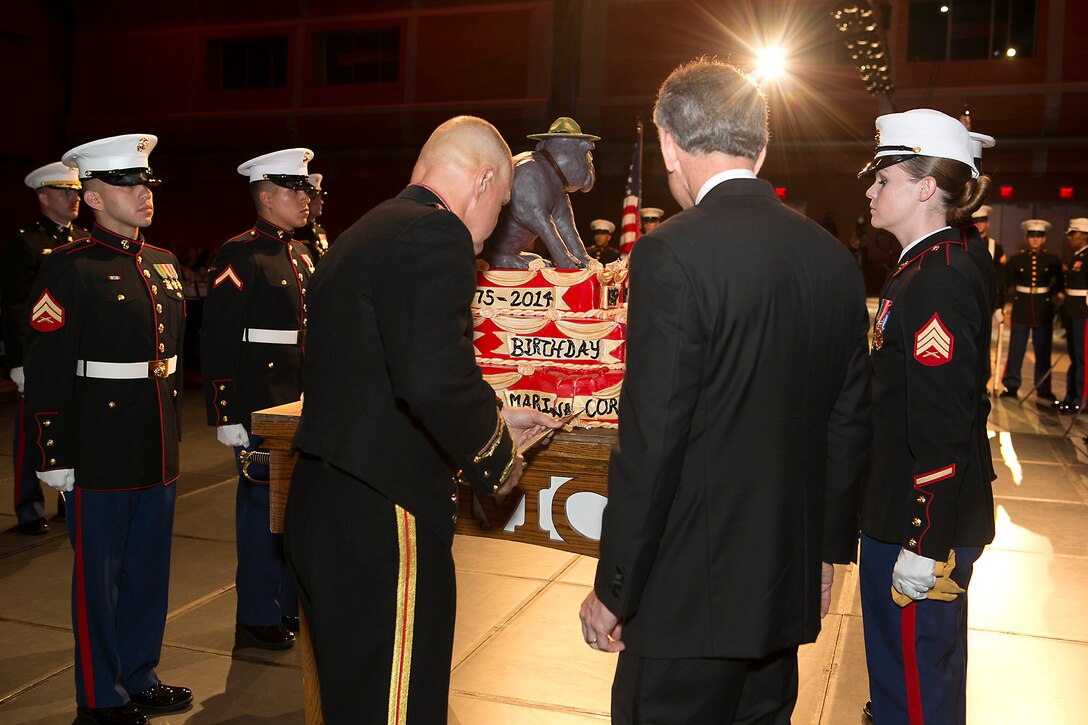 Lt. Gen. Robert B. Neller, U.S. Marine Corps Forces Command (MARFORCOM) commander, cuts the first piece of cake during the MARFORCOM 239th Marine Corps Birthday Ball before presenting it to guest of honor Scott Rigell, U.S. representative of the 2nd Congressional District of Virginia, at the Virginia Beach Convention Center on Nov. 8, 2014. It is customary at Marine Corps birthday celebrations worldwide for Marines to cut a traditional cake in celebration of the birth of the Marine Corps on Nov. 10, 1775. The first piece of cake is given to the guest of honor, and the next piece is given to the oldest and youngest Marines present in the command to symbolize the passing of history and tradition to the next generation, as well as the experience and the youthful spirit that are hallmarks of the Marine Corps. Visit https://www.flickr.com/photos/marforcom/sets/72157648871588429/ for additional photos.