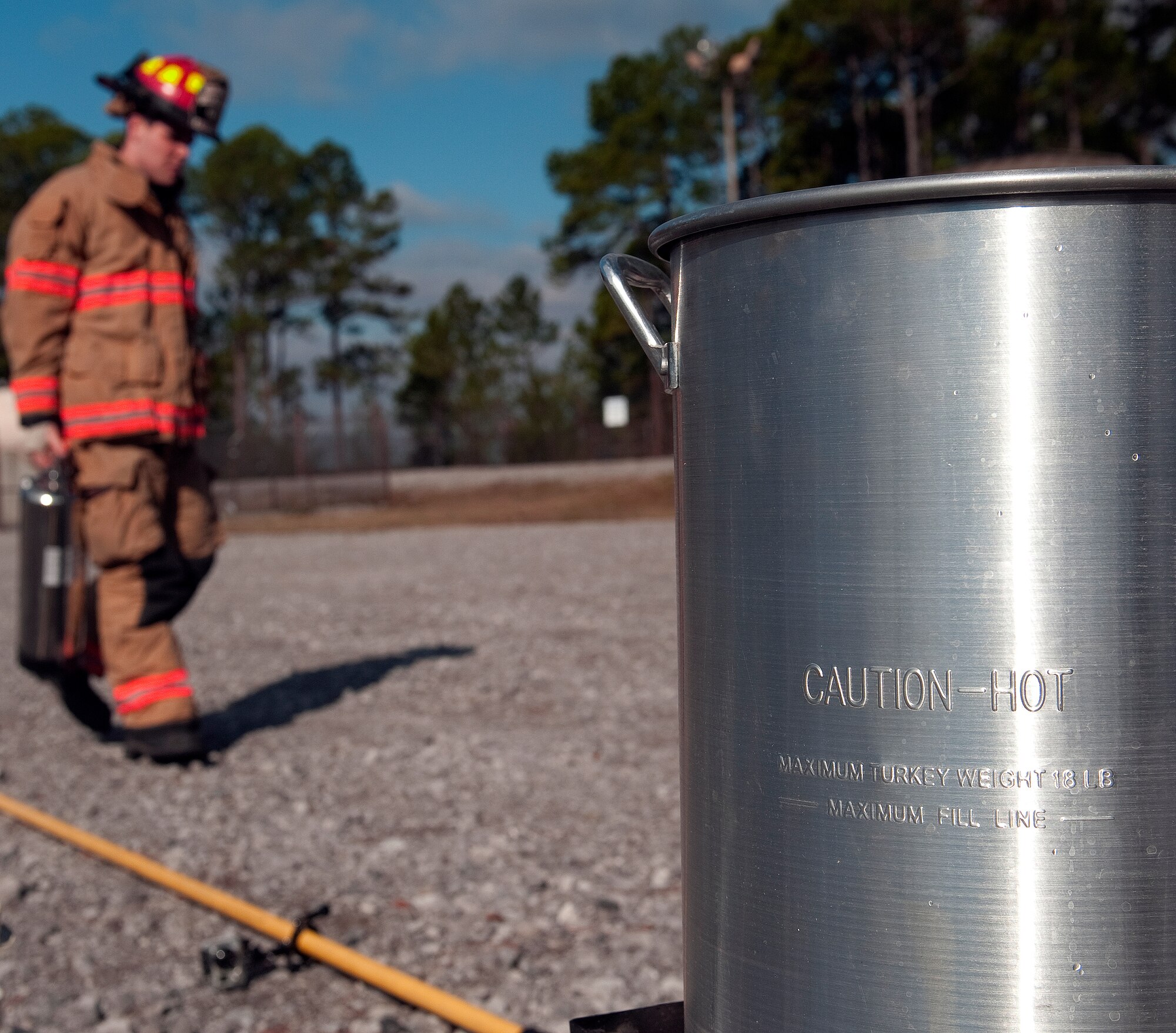 A firefighter from 1st Special Operations Civil Engineer Squadron prepares for a possible turkey fryer fire during a safety demonstration at the fire training area on Hurlburt Field, Fla., Nov. 27, 2013. Once cooking oil is heated beyond its cooking temperature, its vapors can ignite. (U.S. Air Force photo/Senior Airman Kentavist P. Brackin)