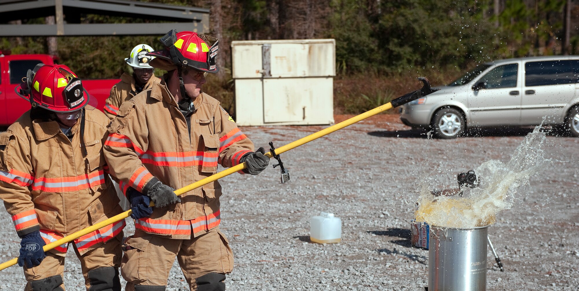 Firefighters from 1st Special Operations Civil Engineer Squadron drop a frozen turkey into hot cooking oil during a safety demonstration at the fire training area on Hurlburt Field, Fla., Nov. 27, 2013. Maintaining a safe distance from buildings and other flammable objects and not overfilling a turkey fryer can prevent potential fires. (U.S. Air Force photo/Senior Airman Kentavist P. Brackin)