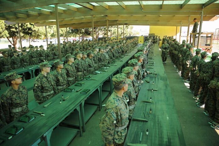 Recruits of Fox Company, 2nd Recruit Training Battalion, listen as Cpl. Cesar Alvarado, armorer, Headquarters Company, Headquarters and Service Battalion, gives instructions during the Rifle Issue event aboard Marine Corps Recruit Depot San Diego, Nov. 3.  During the event, recruits were issued and inspected each piece of their rifle cleaning kit to ensure all the parts were functional and accounted for.  After all gear was inspected, they were issued their M16-A4 Service Rifle.