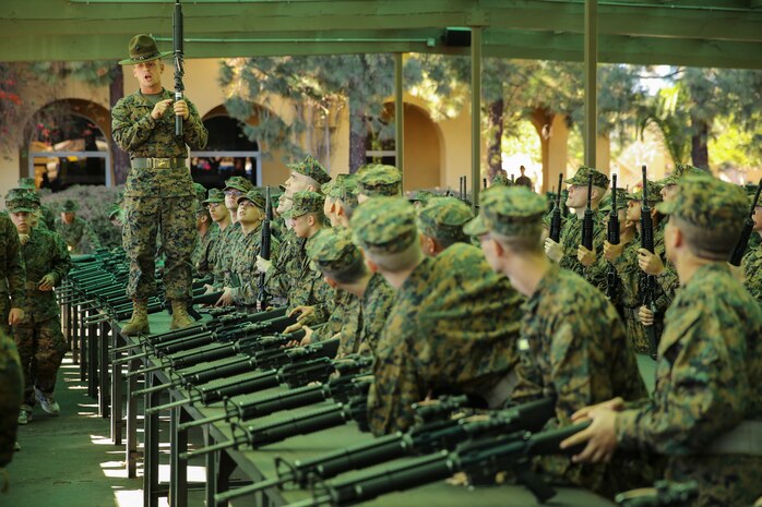 Sgt. Steven J. Kelly, drill instructor, Platoon 2125, Fox Company, 2nd Recruit Training Battalion, teaches recruits how to properly label their newly issued M16-A4 Service Rifle during the Rifle Issue event aboard Marine Corps Recruit Depot San Diego, Nov. 3.  Over the course of recruit training, drill instructors and primary marksmanship instructors will teach recruits all aspects of the rifle, from the cleaning and maintenance to the proper firing utilization of it.