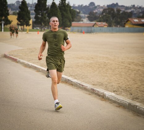 Pfc. Michael R. Gama, Platoon 1074, Delta Company, 1st Recruit Training Battalion, sprints to the finish line during the three-mile portion of the Physical Fitness Test aboard Marine Corps Recruit Depot San Diego, Oct. 30.  Gama endured and overcame family hardship while growing up, which solidified his decision of becoming a United States Marine.
