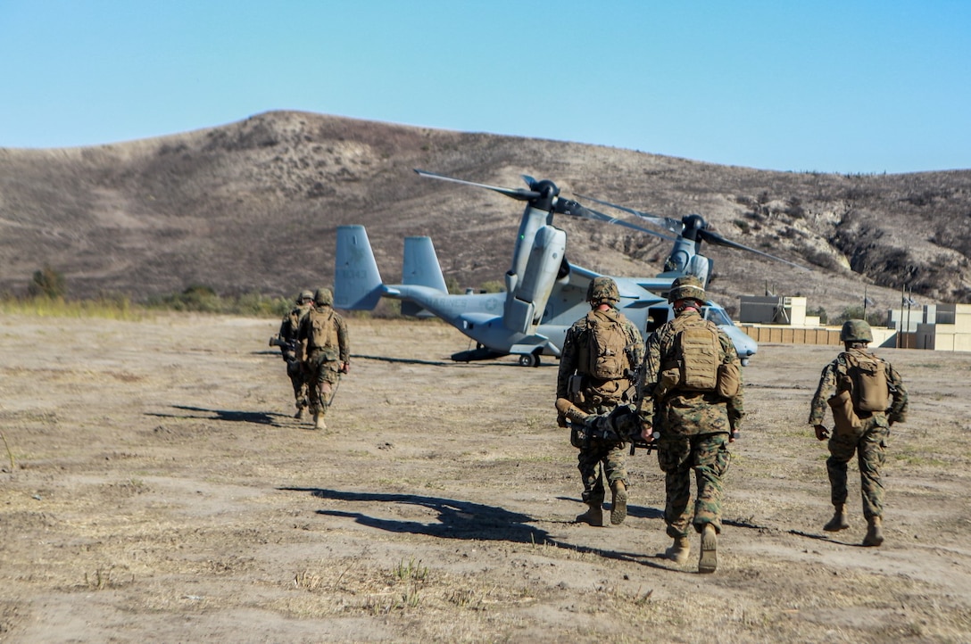 U.S. Marines and U.S. Navy HM3 Nathan Edwards, a senior line corpsman, with India Company, Battalion Landing Team 3rd Battalion, 1st Marine Regiment, 15th Marine Expeditionary Unit carry simulated casualties to load on an MV-22 Osprey during a motorized raid aboard Camp Pendleton, Calif., Nov. 4, 2014. BLT 3/1 is the 15th MEU’s ground combat element. (U.S. Marine Corps photo by Cpl. Steve H. Lopez/Released)