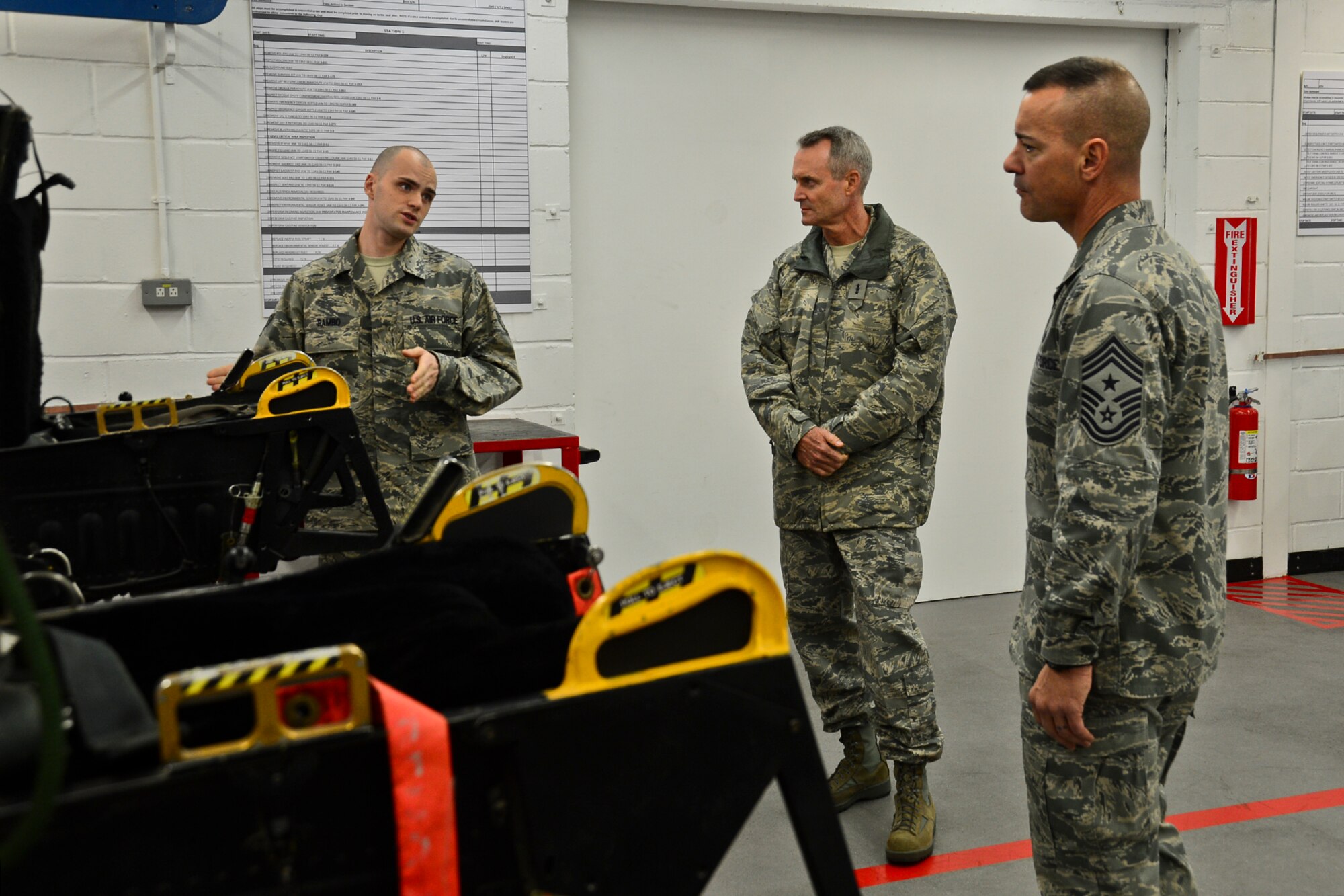Lt. Gen. Darryl Roberson, 3rd Air Force and 17th Expeditionary Air Force commander, and Chief Master Sgt. Mark Marson, 3rd Air Force command chief master sergeant, listen as Senior Airman Kenneth Rambo, 48th Component Maintenance Squadron aircrew egress systems journeyman, explains protocols at the 48th CMS at Royal Air Force Lakenheath, England, Nov. 13, 2014. While visiting the 48th Component Maintenance Squadron, Roberson said he was impressed with the way personnel had recently streamlined their work, maximizing efficiency and cutting costs. (U.S. Air Force photo by Airman 1st Class Erin R. Babis/Released)