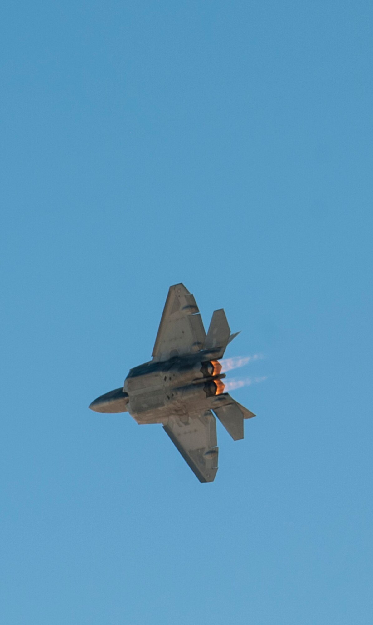 Capt. John Cummings, F-22 Raptor Demo Team commander assigned to the 94th Fighter Squadron from Joint Base Langley-Eustis, Va., pilots an F-22 Raptor from the 53rd Test and Evaluation Group to demonstrate the maneuvering capabilities of the aircraft during the open house at Nellis Air Force Base, Nev., Nov. 7, 2014. The F-22 is a fifth generation fighter aircraft that stores its weapons in an internal weapons bay and is capable of speeds greater than Mach 1.5 without afterburners. (U.S. Air Force photo by Airman 1st Class Thomas Spangler)