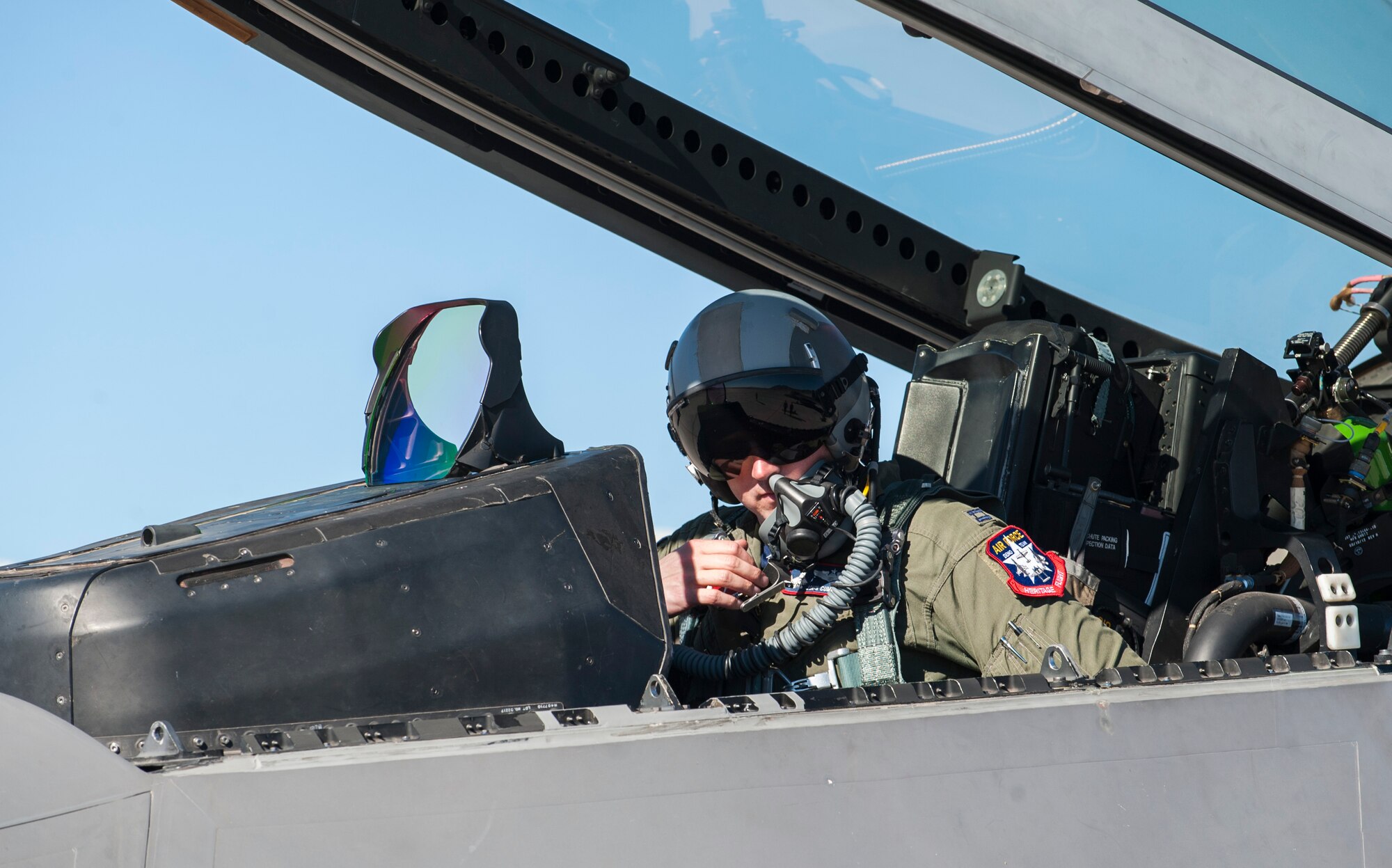 Capt. John Cummings, F-22 Raptor Demo Team commander assigned to the 94th Fighter Squadron from Joint Base Langley-Eustis, Va., goes through pre-flight checks before taxiing to the runway during the open house at Nellis Air Force Base, Nev., Nov. 7, 2014. Cummings is a seasoned fighter pilot with more than 1,000 flying hours in both the F-15C Eagle and the F-22. (U.S. Air Force photo by Airman 1st Class Thomas Spangler)