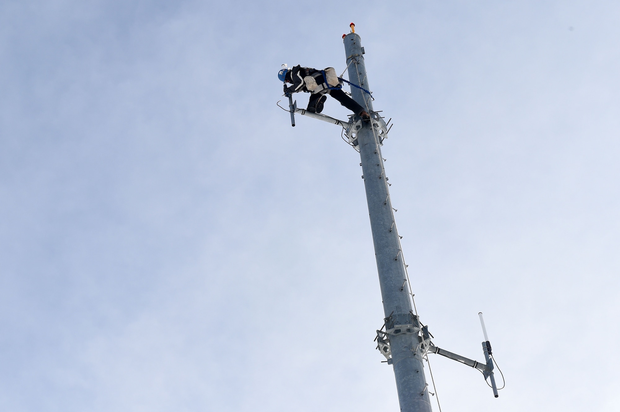 Adam Richter, United Tower Service tower technician, prepares the communication tower for a new antenna during the installation of new equipment on Buckley Air Force Base, Colo. With the installation of the new system, Buckley will now be able to communicate by radio with Peterson AFB, Colorado; F.E. Warren AFB, Wyoming; Shriever AFB, Colorado; and Malmstrom AFB, Montana. (U.S. Air Force photo by Airman Emily E. Amyotte/Released)