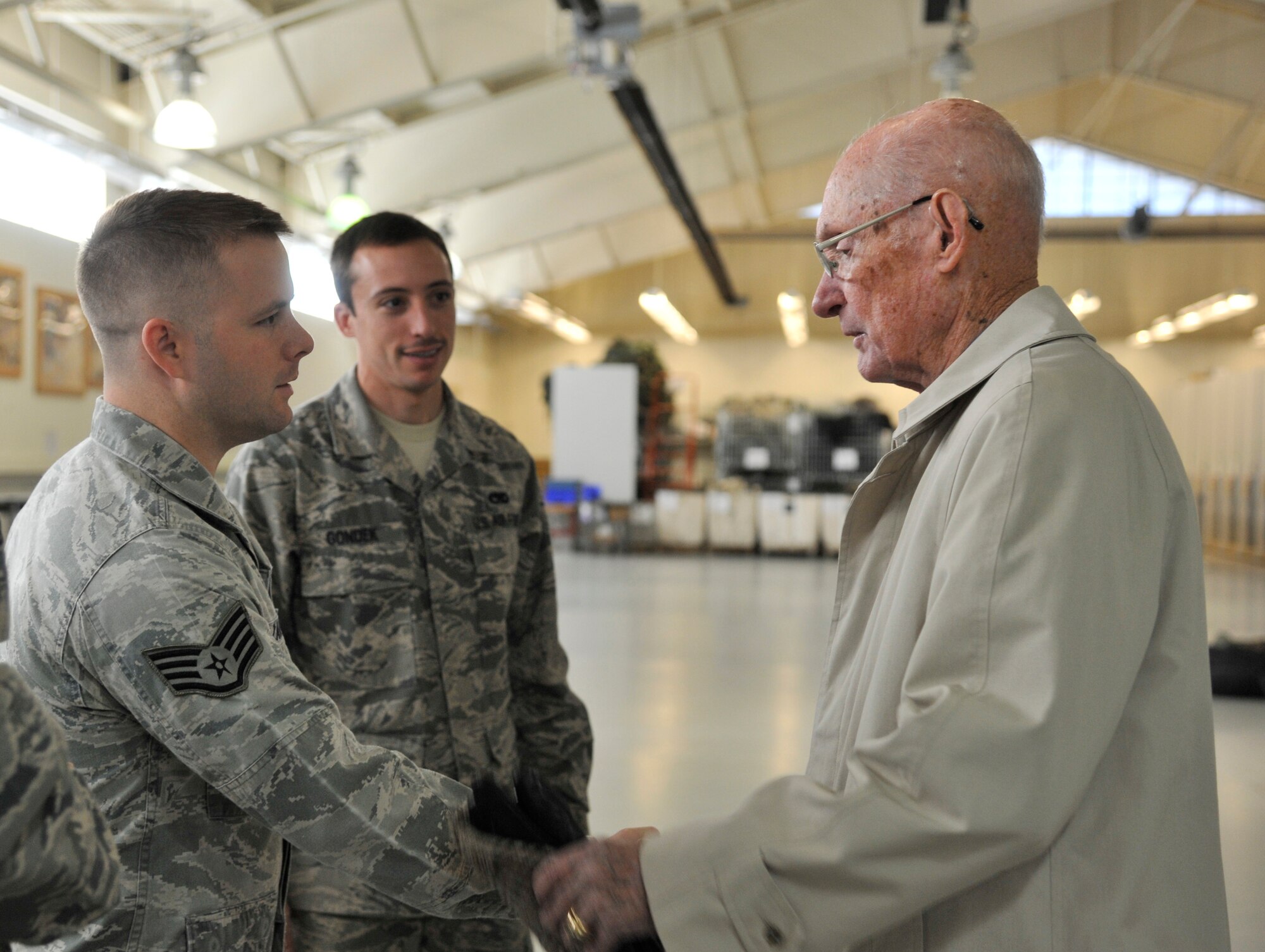 Retired Chief Master Sgt. of the Air Force James McCoy greets Airmen working in the Survival, Evasion, Resistance and Escape logistics building during a tour Nov. 12, 2014 at Fairchild Air Force Base, Wash. McCoy served as the sixth chief master sgt. of the Air Force and toured facilities around base, speaking with Airmen and learning about their day-to-day jobs at Fairchild. (U.S. Air Force photo/Senior Airman Mary O'Dell)