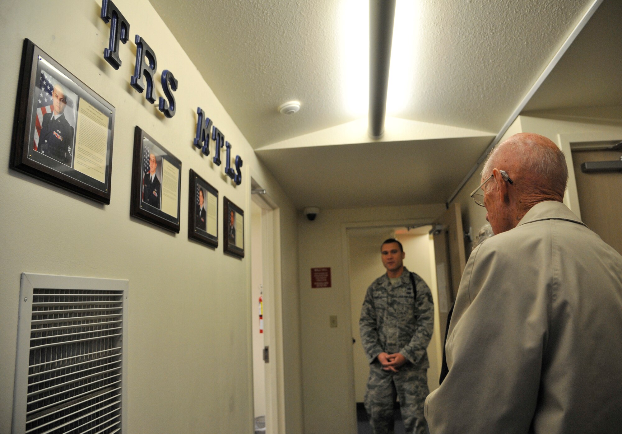Retired Chief Master Sgt. of the Air Force James McCoy looks over the wall of military training leaders for the Survival, Evasion, Resistance and Escape school during a base tour Nov. 12, 2014 at Fairchild Air Force Base, Wash. McCoy was the sixth chief master sgt. of the Air Force and retired from the Air Force in 1981. During his tour, McCoy toured S.E.R.E. facilities including the logistics building and student classrooms. He also spent time touring the maintenance hangars and speaking one-on-one with maintainers. (U.S. Air Force photo/Senior Airman Mary O'Dell)